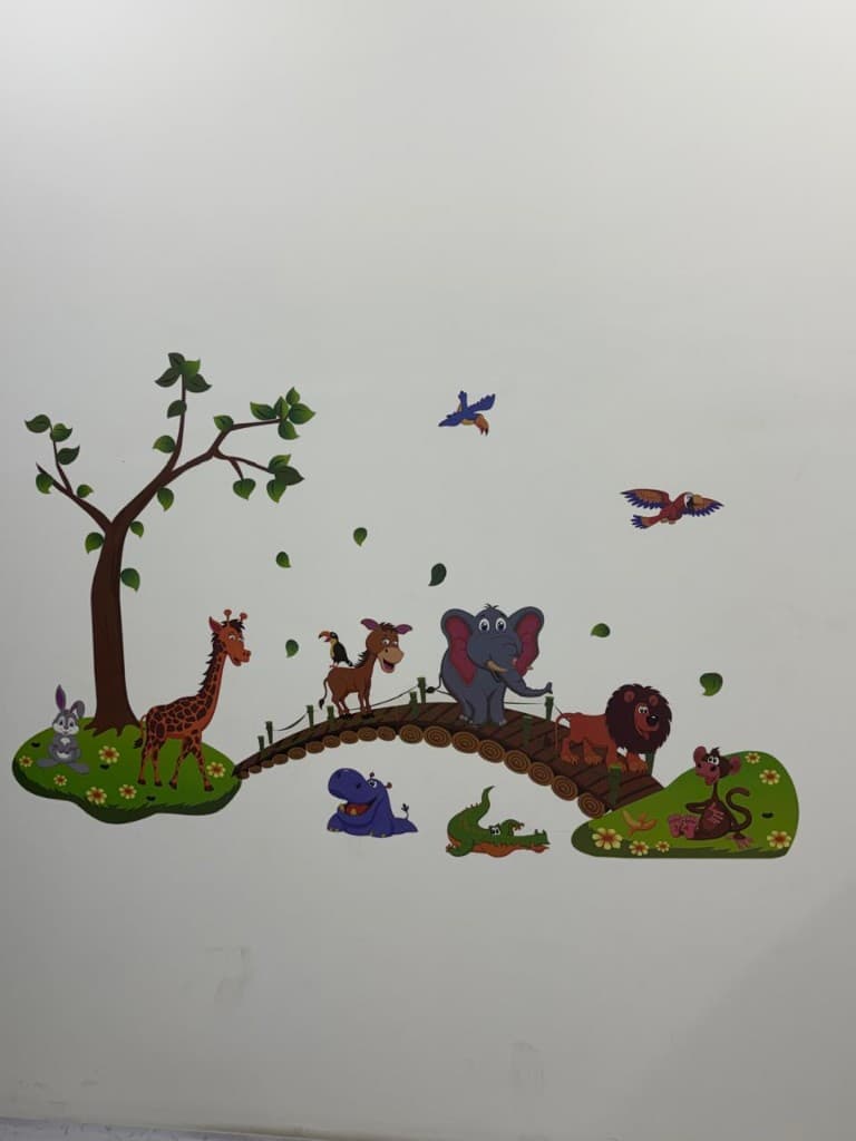 Child-friendly jungle animal wall art in the pediatric clinic