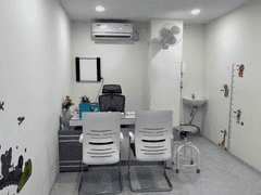 Pediatric consultation room with desk, chairs and child-friendly decor