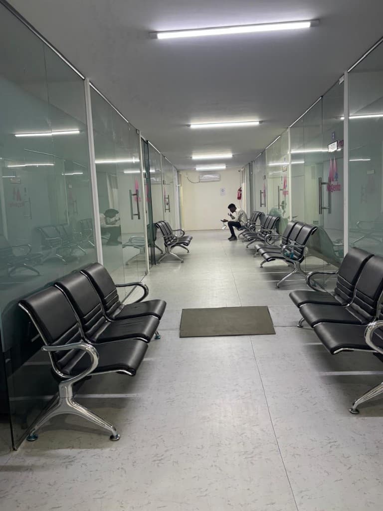 Bright clinic corridor with waiting chairs at Magenta Super Speciality Clinics