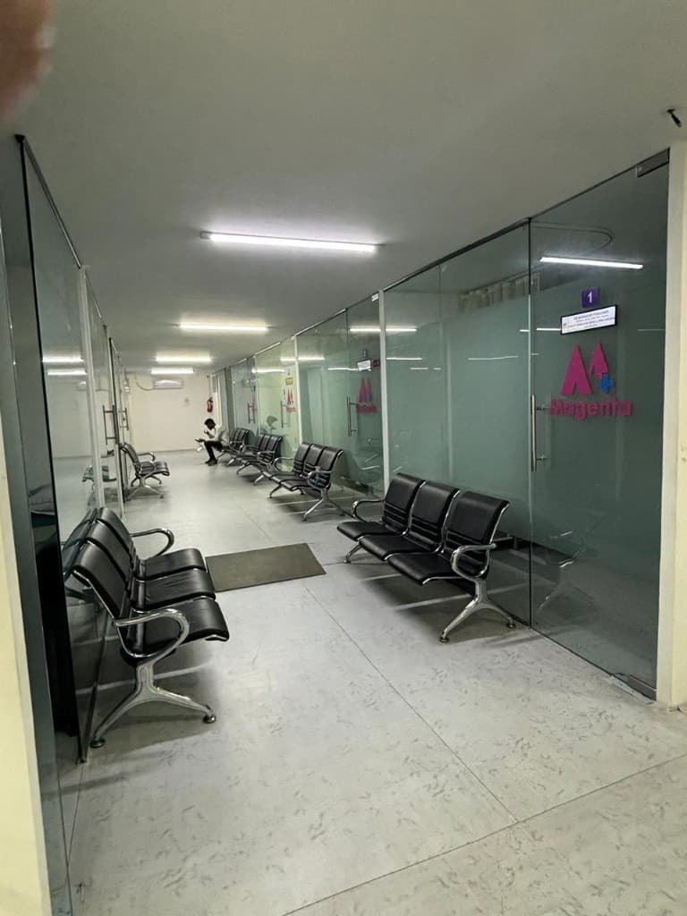 Hallway seating along glass consultation rooms at the clinic